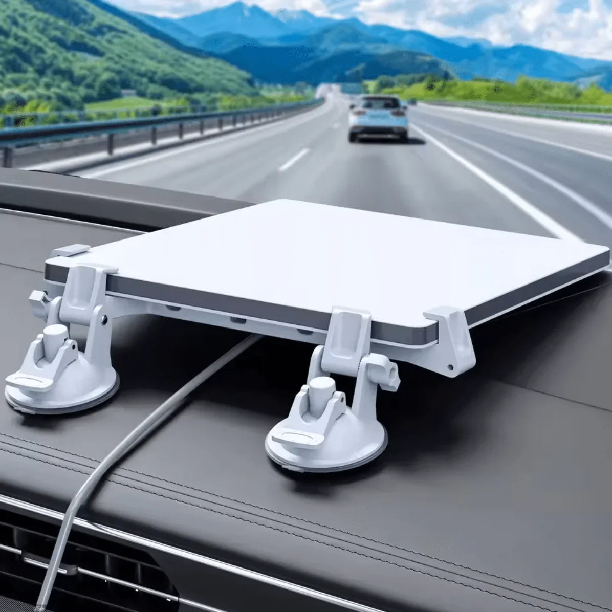 Starlink Flat High Performance antenna mounted on car roof with suction cups, highway background